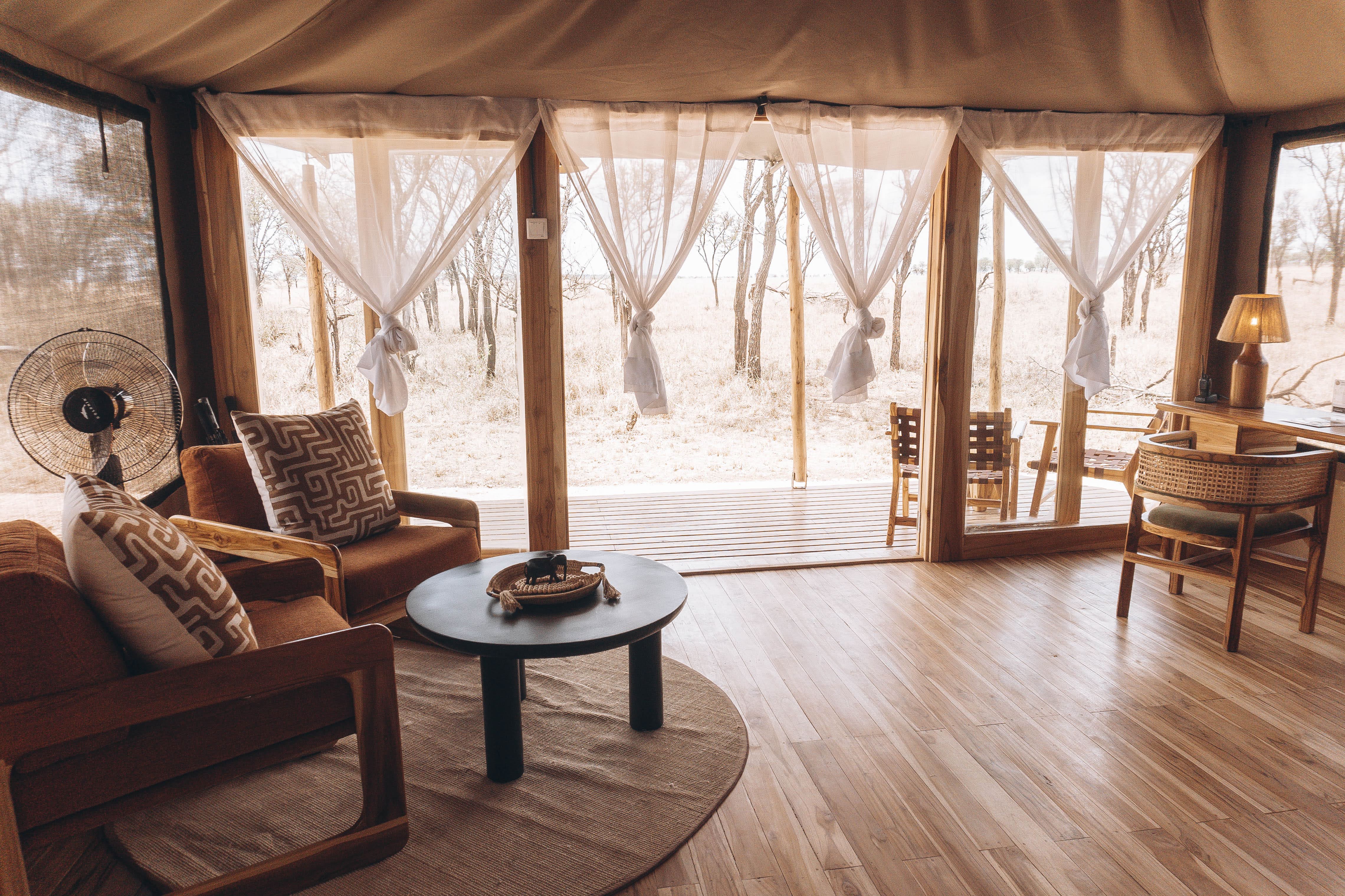 Inside a Conserve Safari Serengeti suite looking out to the deck and bush