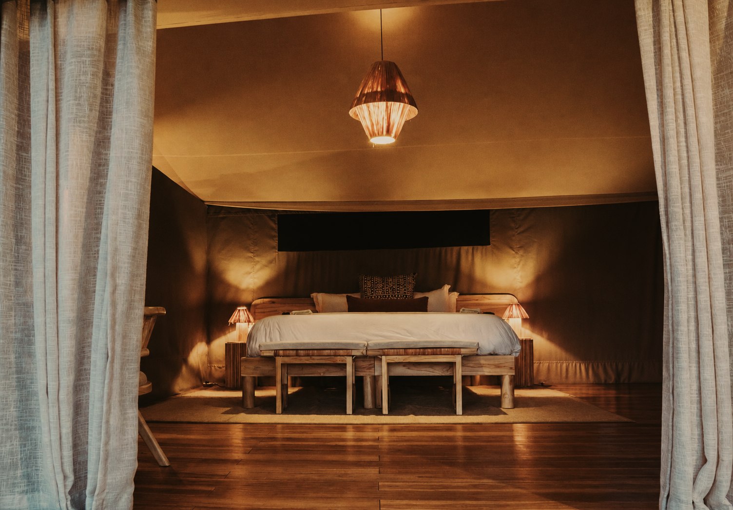 Luxury tent bedroom at night at Conserve Safari Tarangire